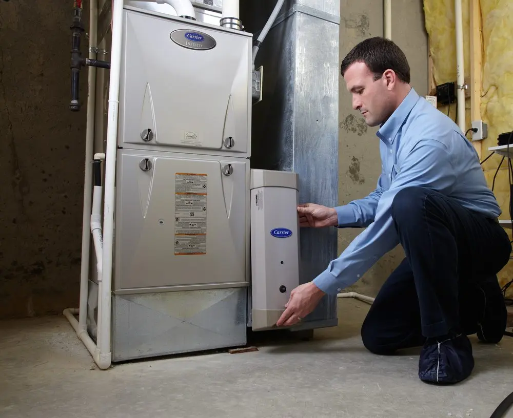Technician servicing an indoor air quality system